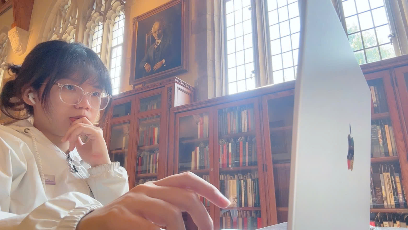 Vi Vu working in a library reading room